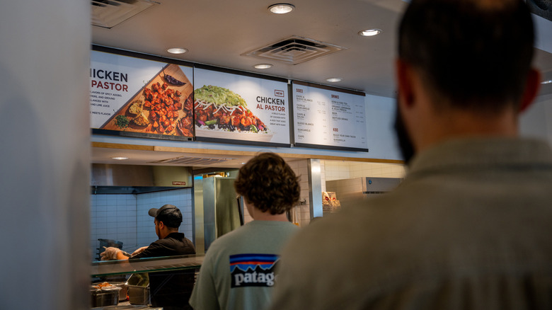 Customers wait in line at a Chipotle