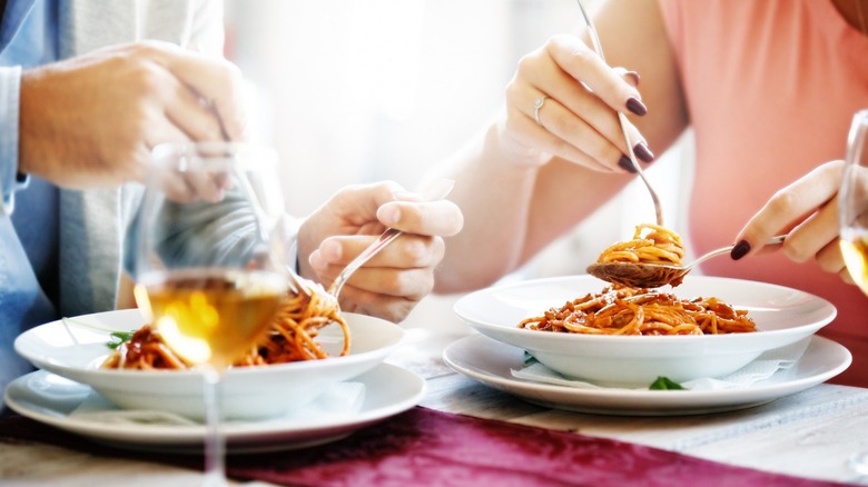 Closeup of couple eating spaghetti
