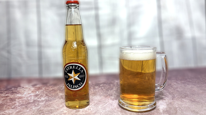 Glass and bottle of Estrella Jalisco beer
