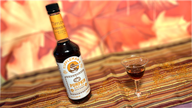 Glass and bottle of Tippleman's pumpkin brûlée syrup
