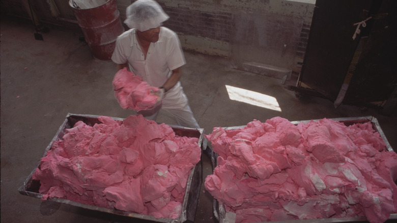 Necco candy factory worker making pink candy batter.