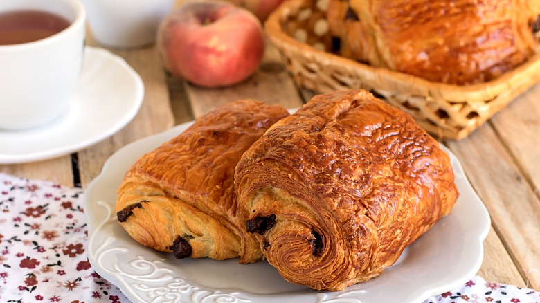 Two chocolate croissants on plate