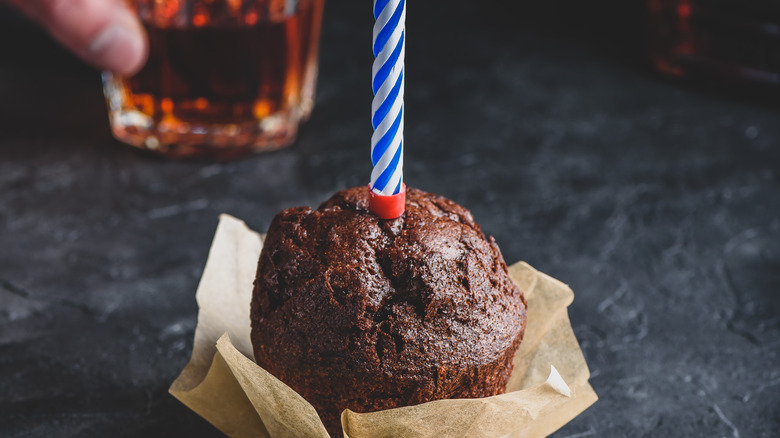 Cupcake with whiskey and candle 