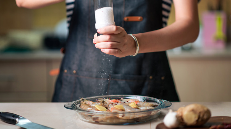 Person salting shrimps