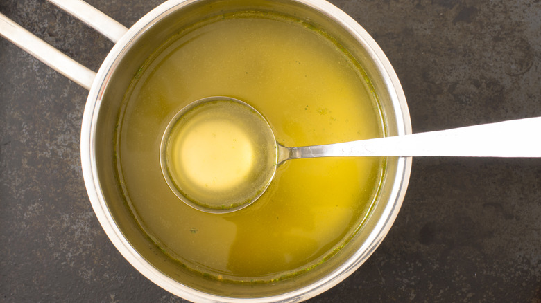 Chicken stock in steel pan steel ladle