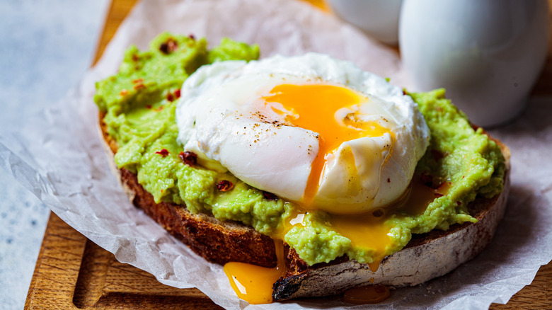 Poached egg on avocado toast runny yolk