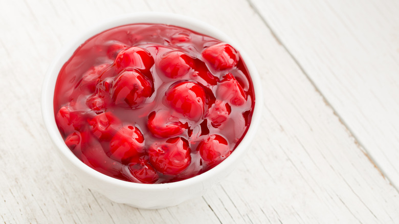 A white bowl filled with cherry pie filling