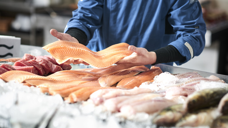 Fishmonger holding a filet 