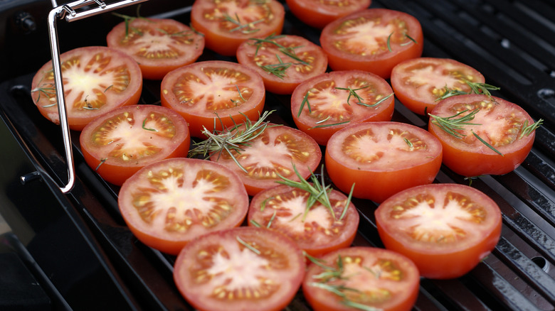 Tomatoes and herbs on grill