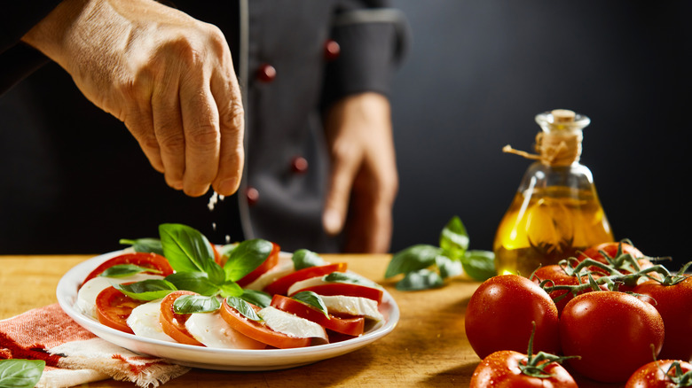 Chef making Caprese salad