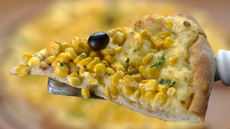 slice of corn pizza with olive