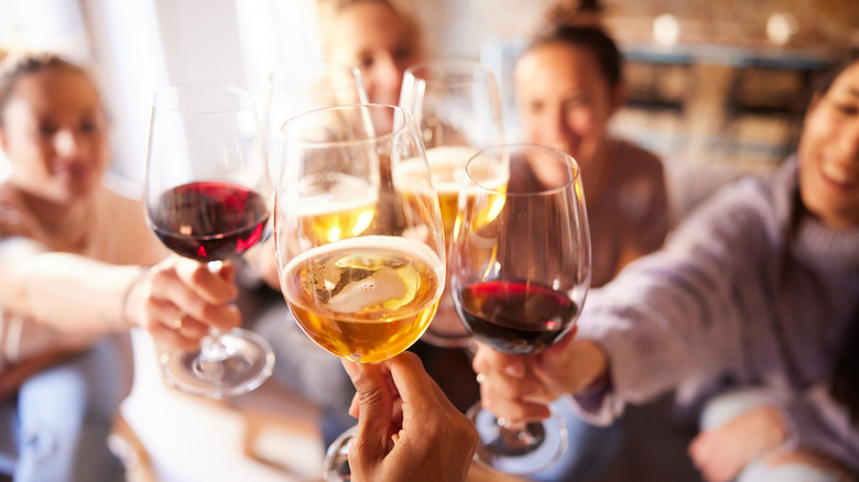 wine glasses being clinked together