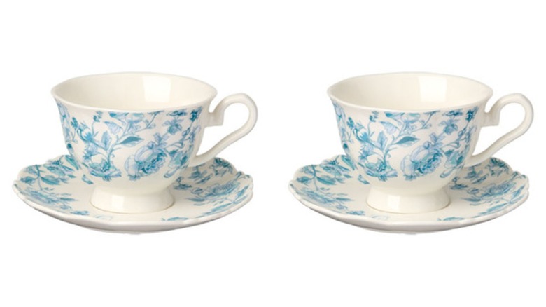 Two white and blue toile teacups with matching saucers