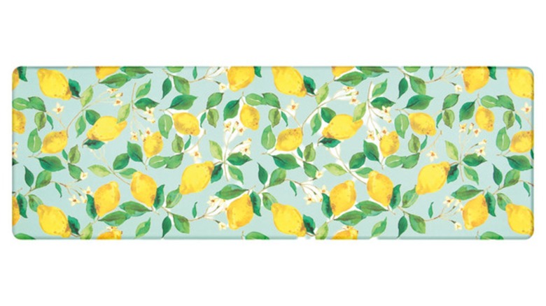 A light blue cushioned runner rug with a lemon tree print against a white background.