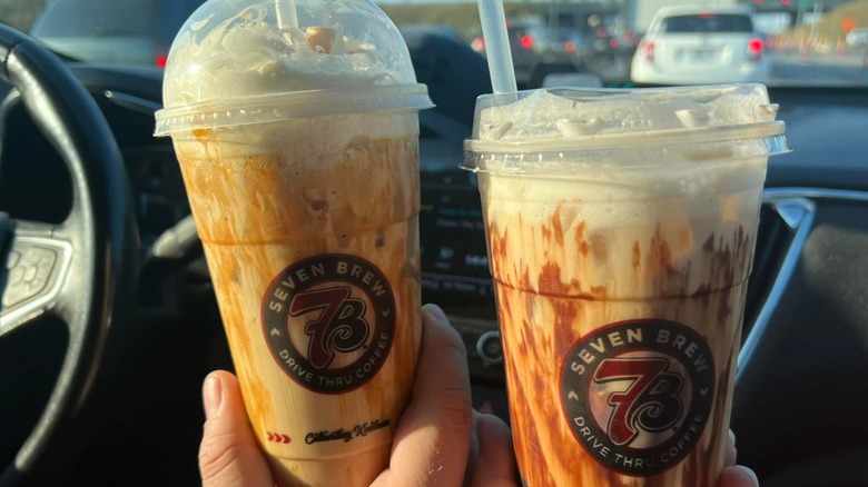 Hands hold a pair of Biscoff Cookie Breve drinks from 7 Brew