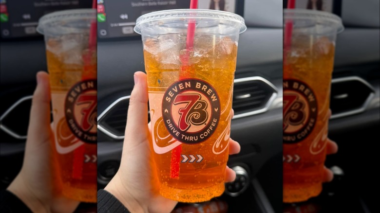 A hand holds a Kokomo drink from 7 Brew