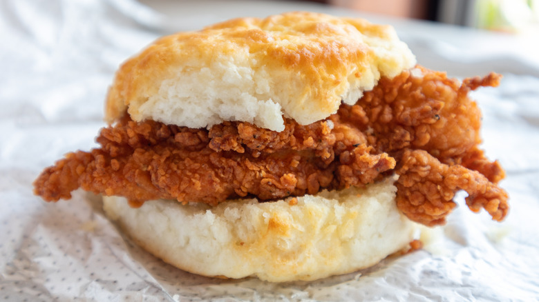 A close-up of a Chick-fil-A chicken biscuit sandwich on paper