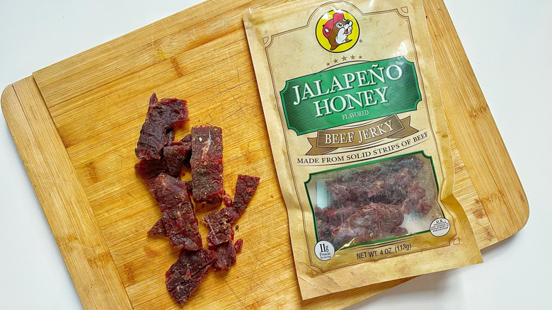 A bag of Buc-ee's Jalapeño Honey jerky on a wooden cutting board