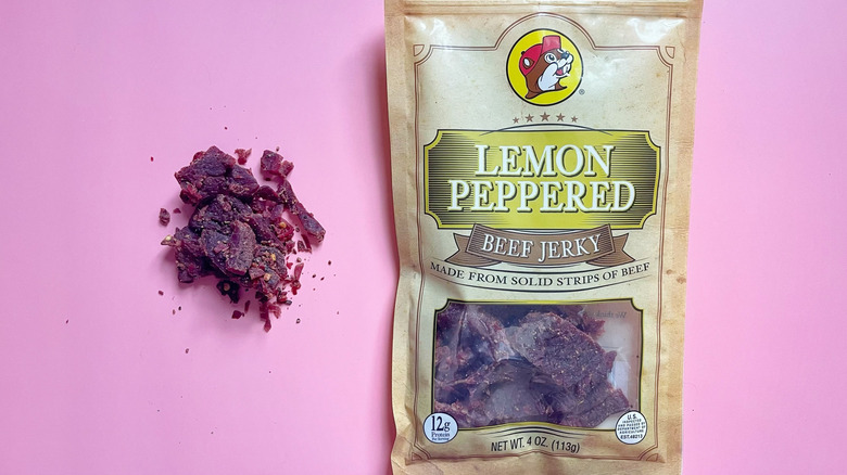 A bag of Lemon Peppered jerky next to a small pile of jerky