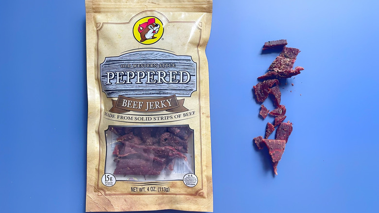 A bag of Old Western Style Peppered jerky next to a line of jerky
