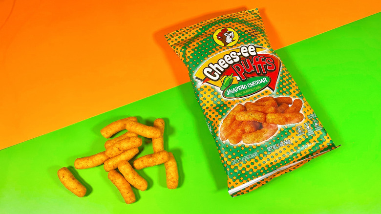 A handful of Chees-ee puffs next to the bag