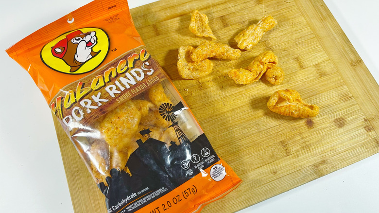 A bag of habanero pork rinds set on a cutting board