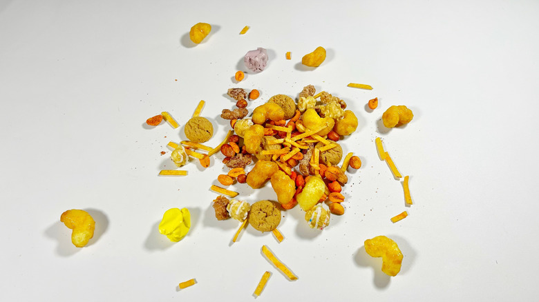 An assortment of snacks spilled onto a white surface