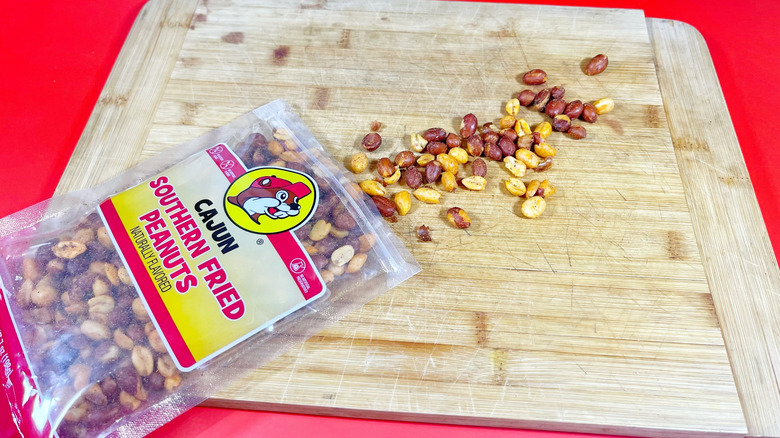 The Cajun Southern fried peanuts spilling onto a cutting board