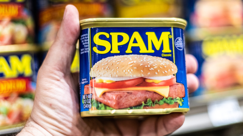 A shopper holding a can of SPAM Classic