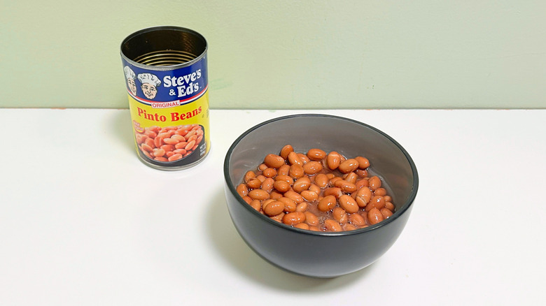 A can of Steve's and Ed's Original Pinto Beans next to a bowl of pinto beans