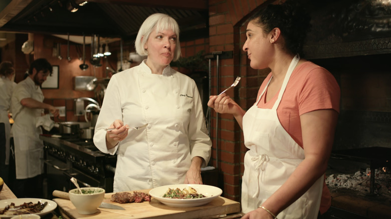 Nosrat and chef eat meal and talk in Salt Fat Acid Heat