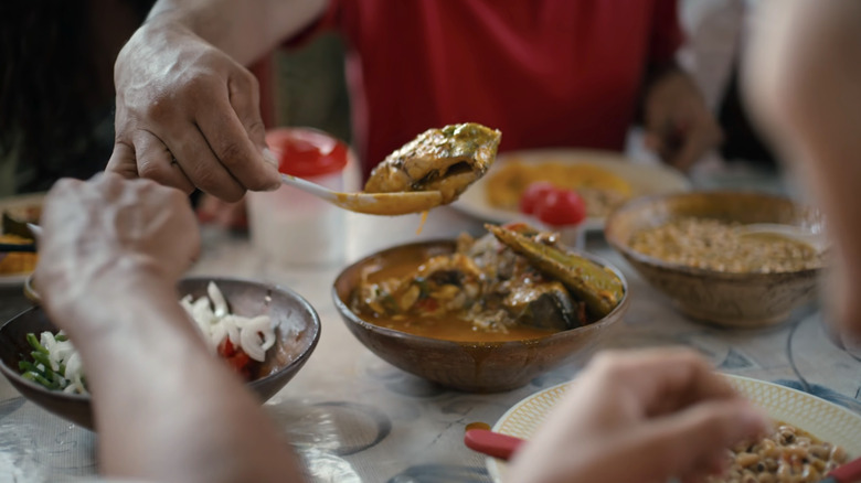 Hands serve food on Street Food: Latin America