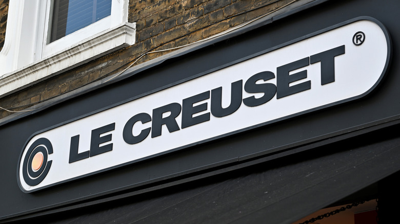 The storefront of a Le Creuset store, focusing on its sign