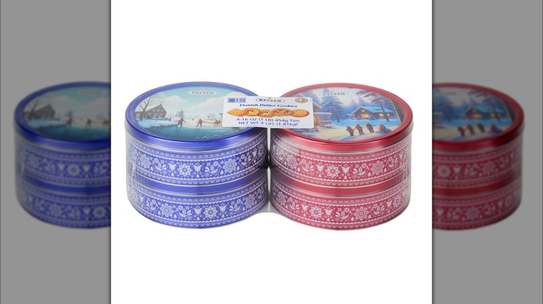 A four count of round metal tins of Danish butter cookies