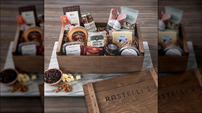 A wooden crate filled with various charcuterie supplies