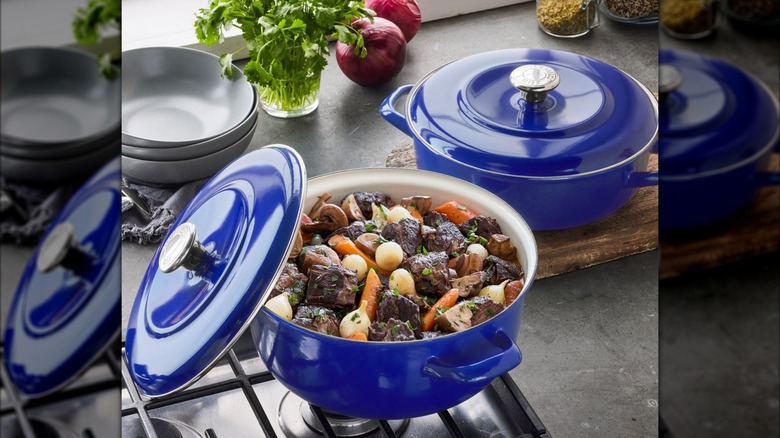 A rich blue braiser and Dutch oven, with the latter containing beef stew