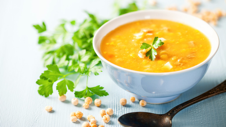 Yellow pea soup in white bowl