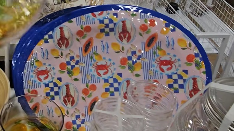 Blue-rimmed tray with crab and lobster pattern on HomeGoods shelf.
