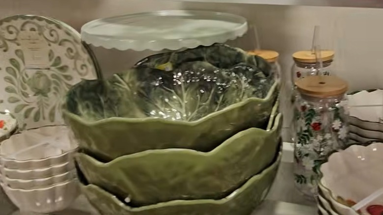 Stacked serving bowls shaped like lettuce leaves on HomeGoods shelf.