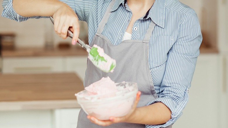 Person making pink whipped cream