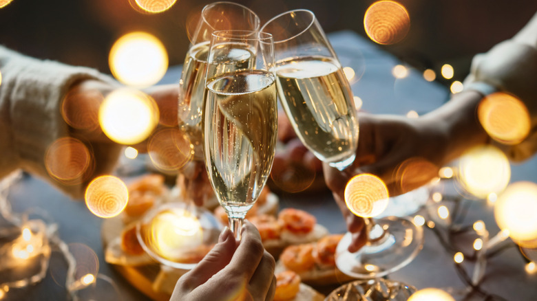 champagne glasses clinking at New Year's party