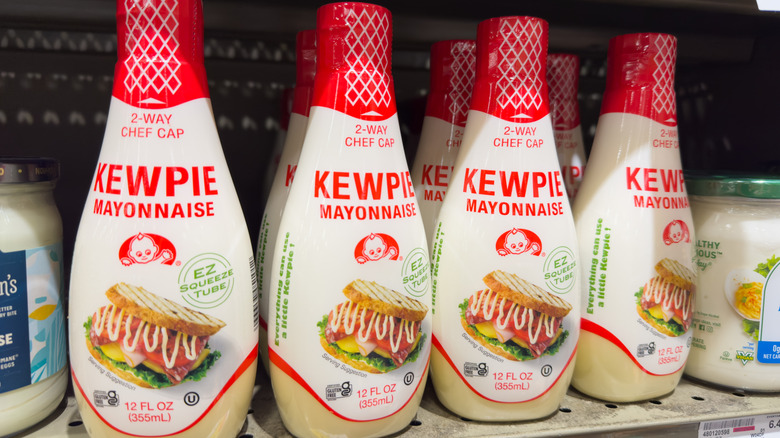 Bottles of Kewpie mayonnaise arranged on a supermarket shelf