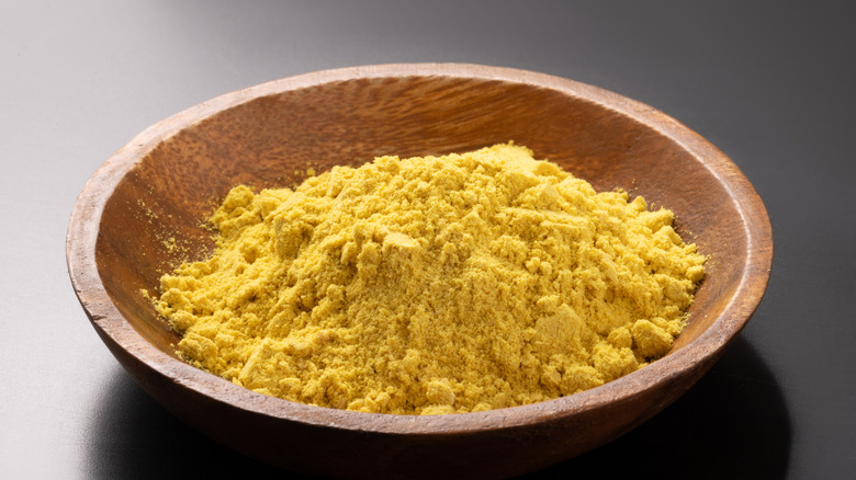 A wooden bowl of mustard powder