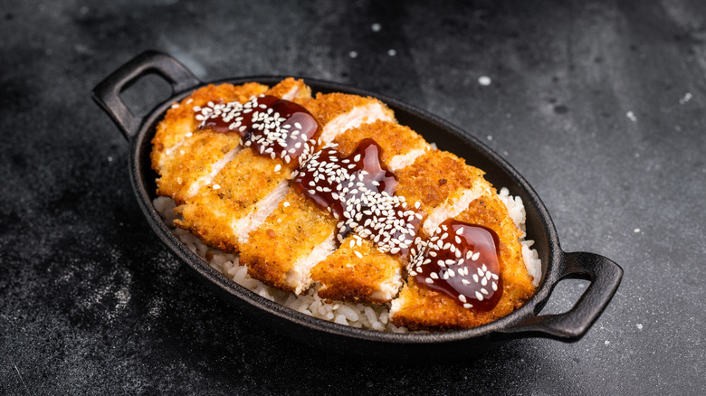Pork tonkatsu, with tonkatsu sauce and sesame seeds on top