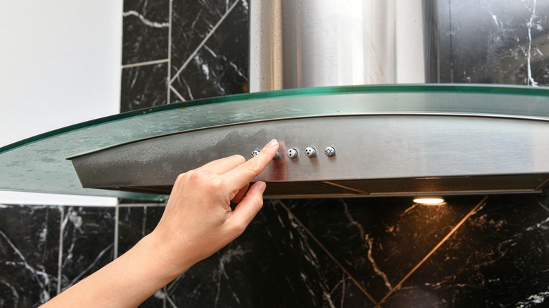 Person turning off range hood
