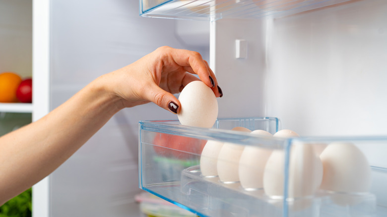 Grabbing egg from fridge