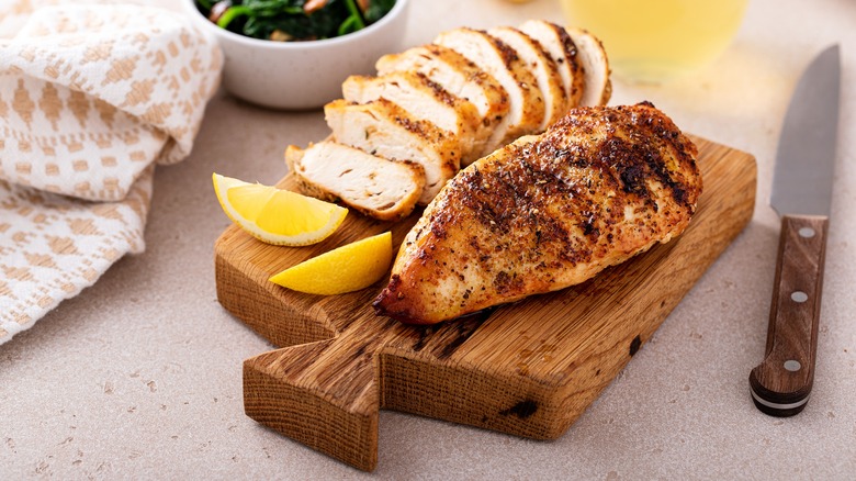 chicken breast on wooden board
