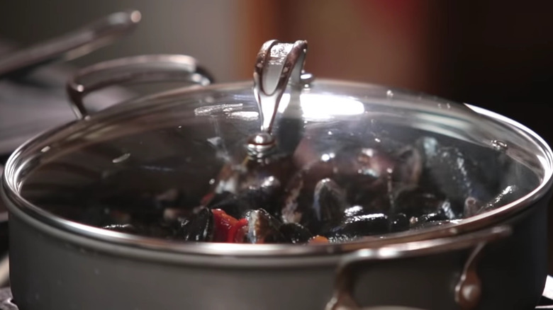 Mussels steaming in covered pot 