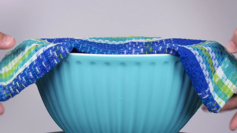 Bowl covered by damp teatowel