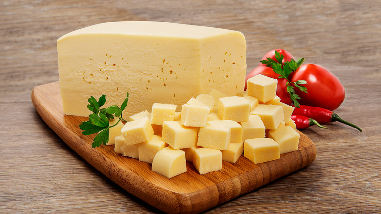 Mozzarella cubes on wood board